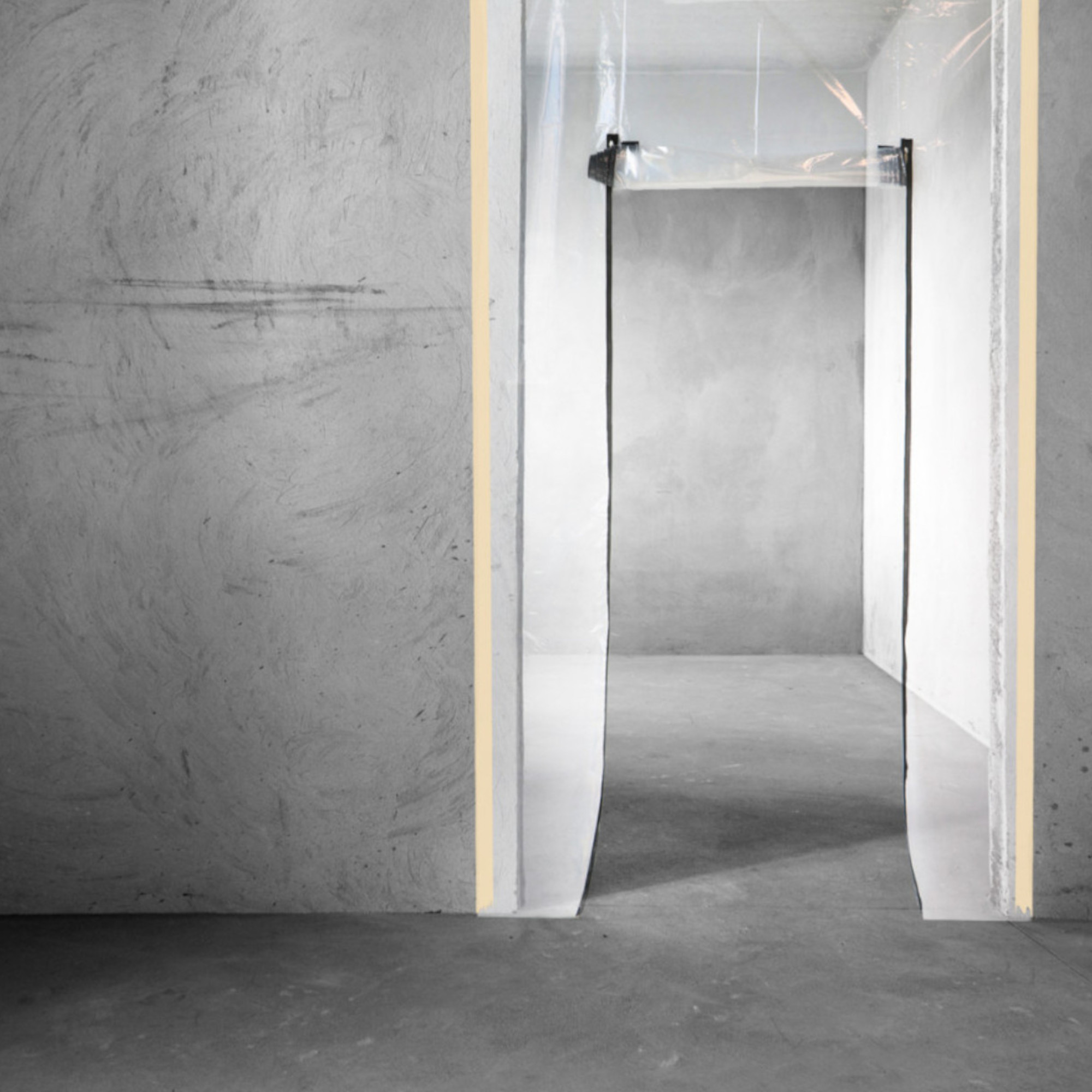 Ein Raum mit grauen Wänden und einem offenen Durchgang. Der Durchgang ist mit transparentem Material umgeben und hat eine helle, gelbe Markierung. Der Boden ist ebenfalls grau und der gesamte Raum wirkt minimalistisch und modern.